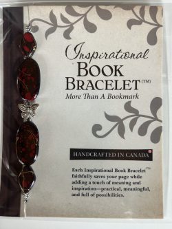 Packaged Inspirational Book Bracelet featuring dark maroon-black oval beads with crimson speckles, matching diamond-shaped end beads, and a central silver butterfly spacer mounted on a branded backing card.