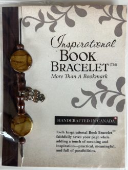 Packaged Inspirational Book Bracelet featuring earthy brown marble disc beads, carved dark wooden cylinder spacers, and a dangling silver owl charm mounted on a branded backing card.