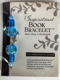 Packaged Inspirational Book Bracelet featuring bright aqua-blue disc beads, square accents, textured silver tubes, and a dangling silver dolphin charm mounted on a branded backing card.