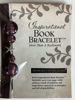Packaged Inspirational Book Bracelet featuring deep purple disc beads with metallic foil cores, faceted purple accent beads, and a dangling silver starfish charm mounted on a branded backing card.