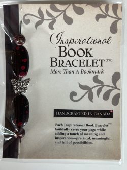 Packaged Inspirational Book Bracelet featuring dark maroon-black oval beads with crimson speckles and a central silver butterfly spacer mounted on a branded backing card.