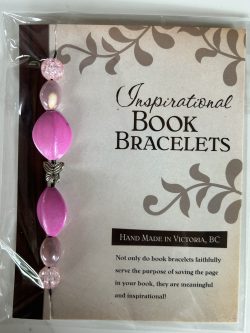 Packaged Inspirational Book Bracelet featuring bright magenta oval beads, soft blush pink accent beads, and a central silver butterfly spacer mounted on a branded backing card.