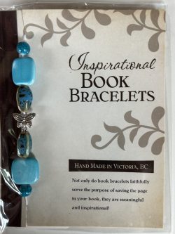 Packaged Inspirational Book Bracelet featuring smooth turquoise cushion square beads, speckled brown-teal ceramic accents, and a silver butterfly spacer mounted on a branded backing card.